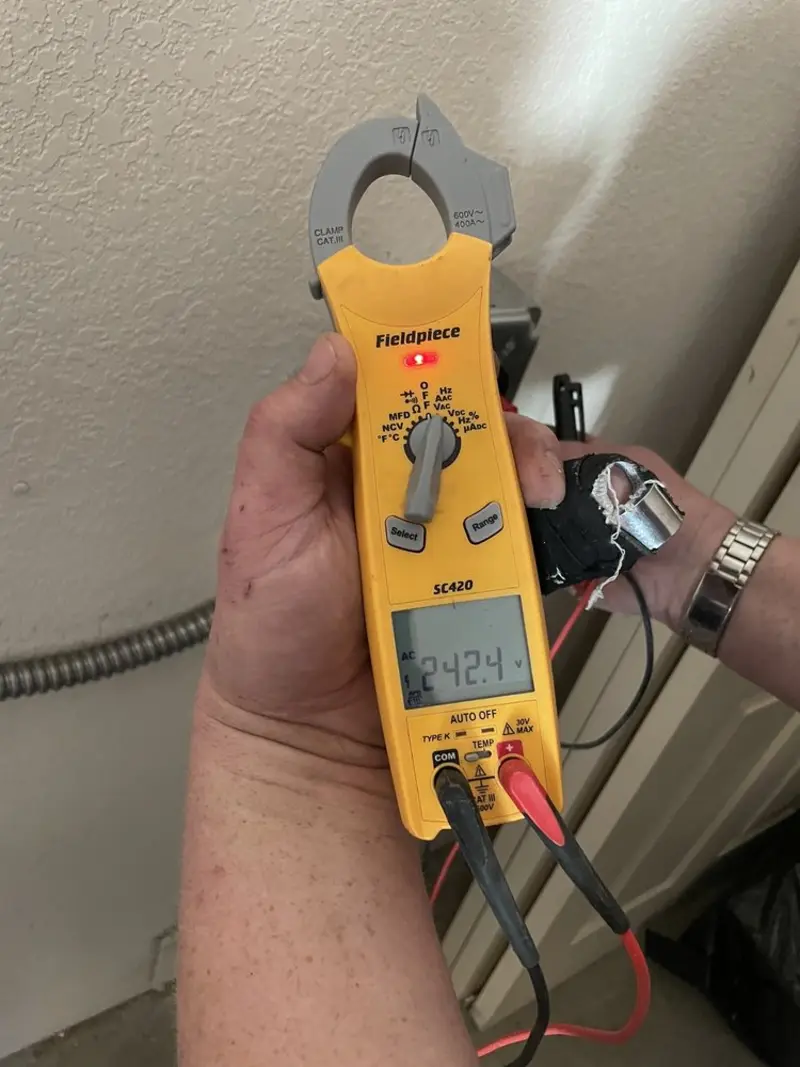 Voltage testing with clamp meter during Whole House Surge Protector in Tyngsborough